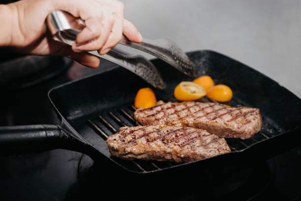 istock Close up raw wagyu beef striploin steak with pepper on dark pan 1341294619