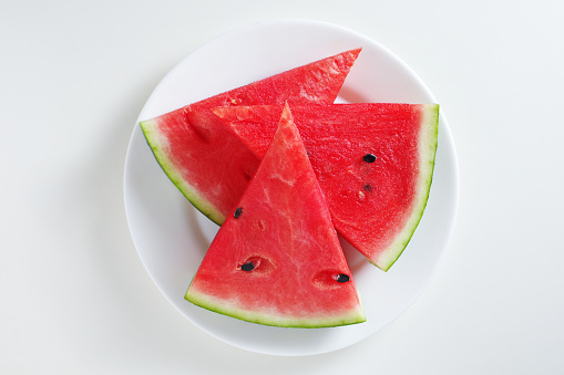 Watermelon slices in plate isolated on white background, top view