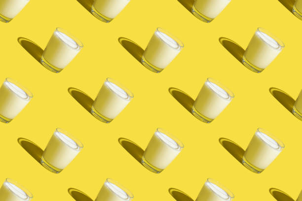 istock World Milk Day. Pattern on a yellow background. A glass of milk. Sample. 1341294636