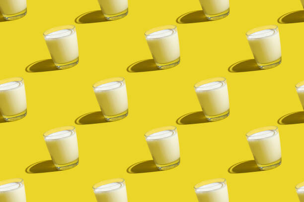 istock World Milk Day. Pattern on a yellow background. A glass of milk. Sample. 1341294638
