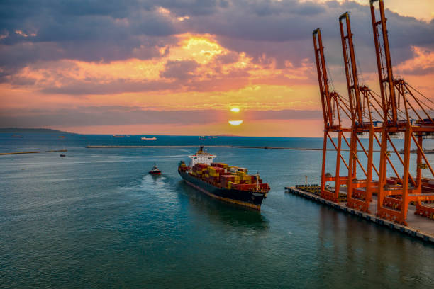 istock Loaded cargo container ship leaving port at sunset, 1341295181