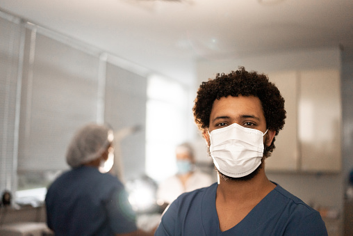 Portrait of a young male nurse wearing protective face mask in a hospital