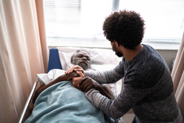 istock Young man visiting hospitalized father 1341295508