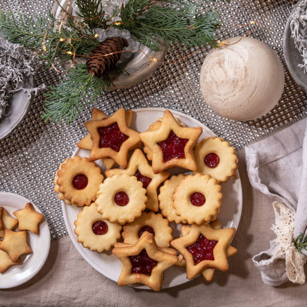 istock Christmas Linz shortbread biscuits cookies with wooden decorations on xmas table. Flat lay 1341295572
