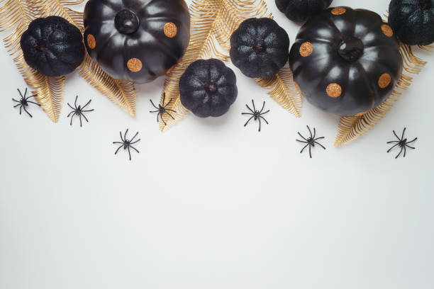 istock Modern Halloween holiday greeting card design with pumpkin and decorations on white background. Banner or poster template mock up. Top view with copy space 1341297028