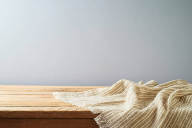 istock Empty wooden table with modern tablecloth over  gray background.  Kitchen mock up for design and product display. 1341297042
