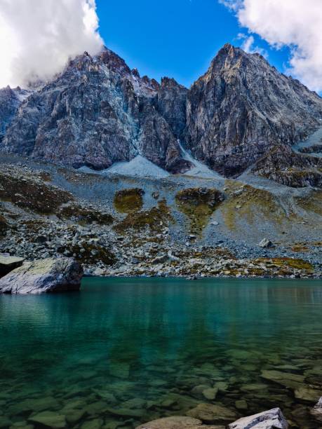 istock green alpine lake surrounded by imposing peaks 1341297136