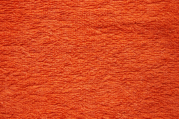 istock Textile background from an orange terry towel 1341298057
