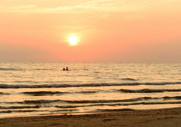 couple in sea at sunset
