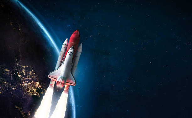istock Spaceship in the outer space on orbit of Earth planet. Space shuttle in sky with clouds. Continents and oceans. Elements of this image furnished by NASA 1341299556