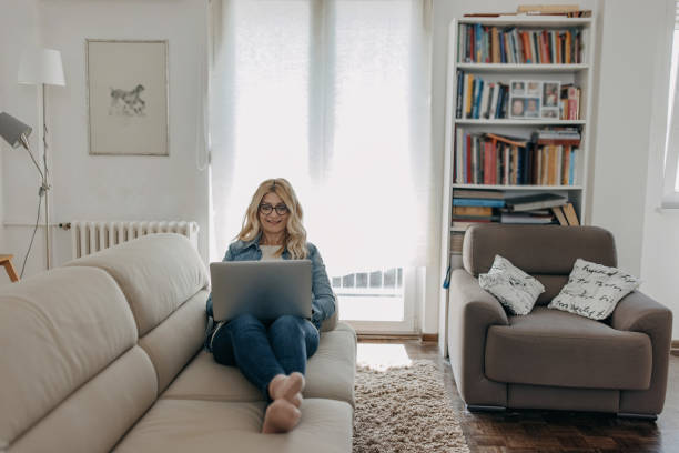 istock Mid adult woman using laptop 1341307136