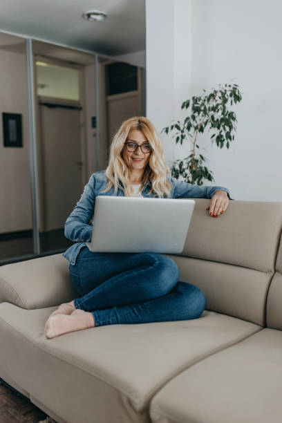 istock Mid adult woman using laptop 1341307176