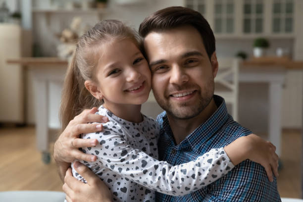 istock Happy dad holding cute daughter kid in arms 1341308135