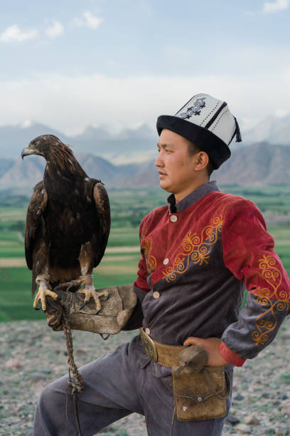 istock Eagle hunter standing on the background of mountains  in Kyrgyzstan 1341309708