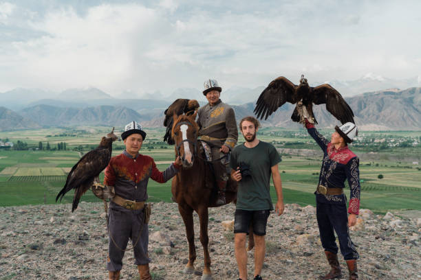 istock Three eagle hunters and photographer standing  in steppe in Kyrgyzstan 1341309987