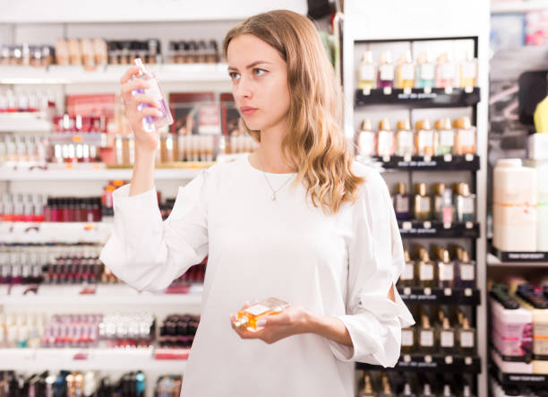 istock Girl buying perfume in makeup store 1341310396
