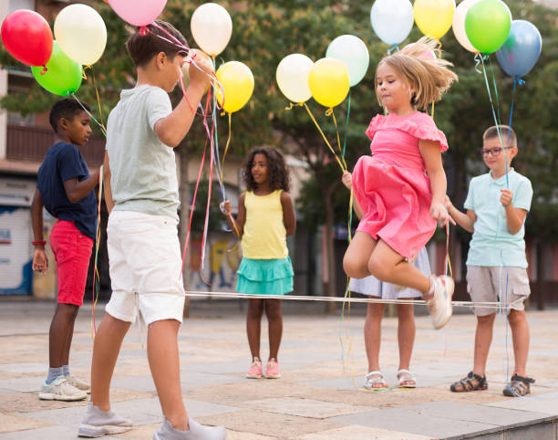 istock Children playing with balloons and jumping rope 1341311958