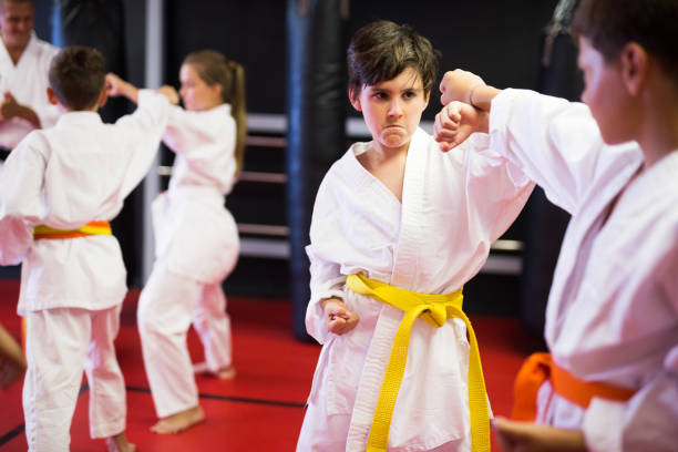 istock Two boys working in pair, mastering new karate moves 1341312648