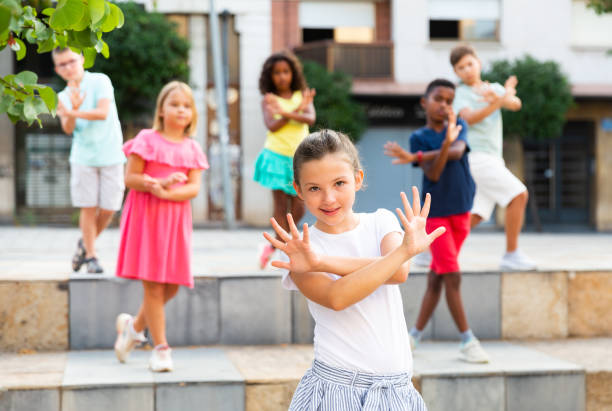 istock Smiling tween girl street dancer posing during performance with group 1341312969