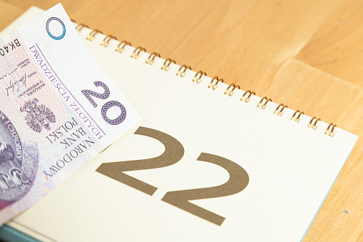 20 PLN (twenty Polish zlotys and 2022 calendar cover on wooden table