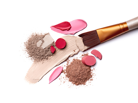 The makeup products. Brush and eyeshadow powder isolated on white background.