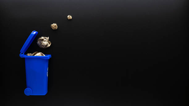 istock Recycle paper garbage. Blue dustbin for recycle paper trash on black background. Bin container for disposal garbage waste and save environment. Copy space. 1341314115