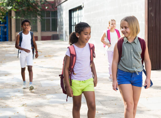 istock Schoolgirls walking together 1341314488