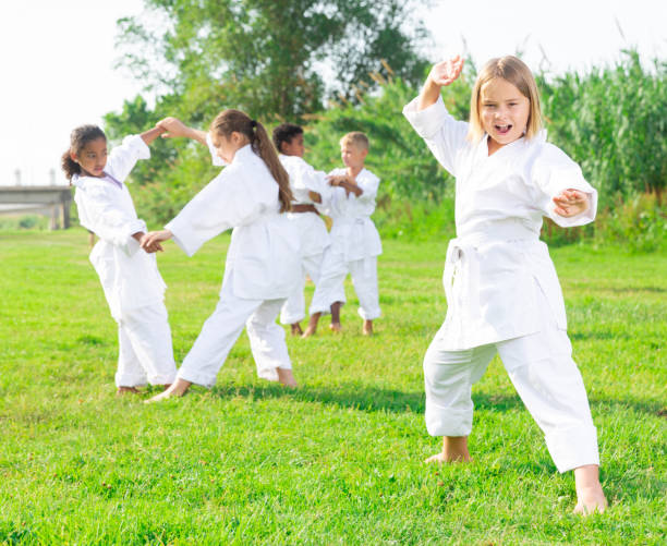 istock Little girl make karate exercises in park 1341314609