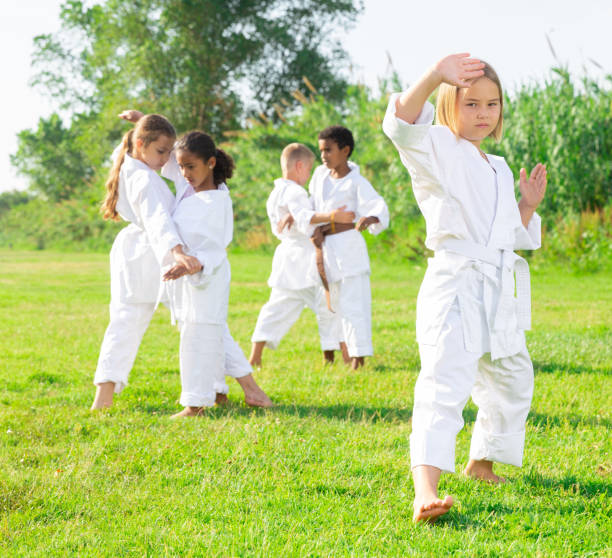 istock Little girl make karate exercises in park 1341314619