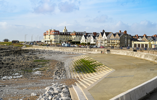Porthcawl, Wales - February 2020: New concrete foreshore and sea defences in Porthcawl. The concrete is covered in green algae