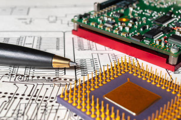 istock Electronic board, pen, processor and radio components lie on the background of an schematic circuit diagramm and a photomask for the manufacture of printed circuit boards. Concept for the development and design of electronic devices. 1341316892