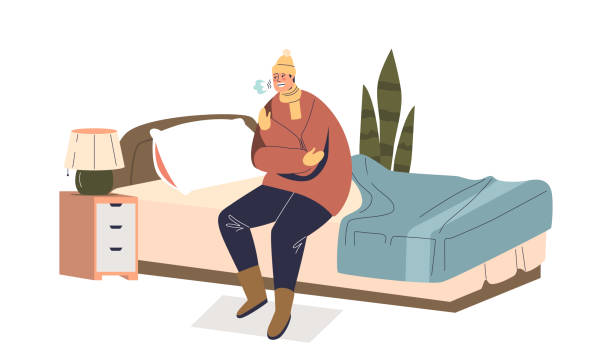 Man shivering from cold sit on bed dressed in warm clothes and hat in bedroom indoors Man shivering from cold sit on bed dressed in warm clothes and hat in bedroom indoors. Male freezing at home in winter season. Cartoon flat vector illustration shivering stock illustrations