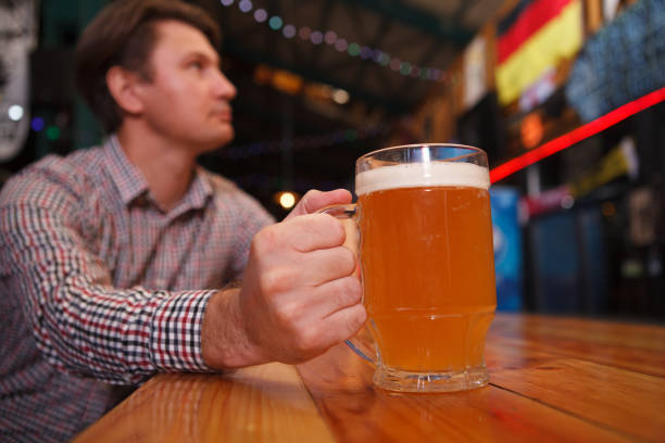 istock Man drinking at beer pub 1341318750