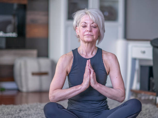 istock Senior Female Meditating 1341319796