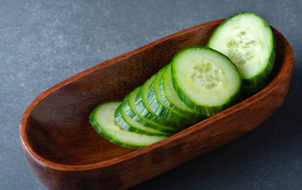 istock fresh cucumber sliced in a plate on table. 1341320539