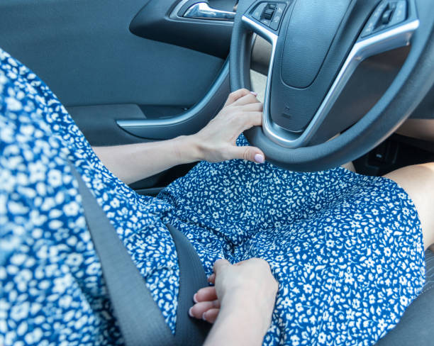 istock Woman driving a car, wrong hand position on the steering wheel. 1341320567