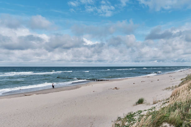 istock Beautiful seascape with waves, sandy beach and cloudy sky. 1341324176