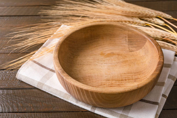 istock Empty plate on napkin on wooden table over grunge blue background. 1341325353