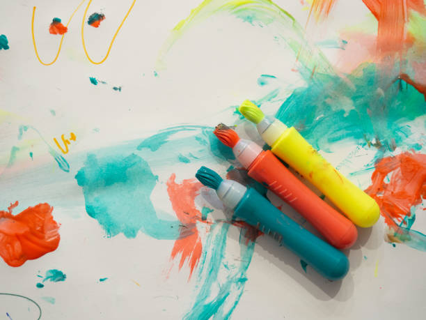 istock kid colored markers with brush stroke lines on painted white paper background Macro Selective focus 1341326196