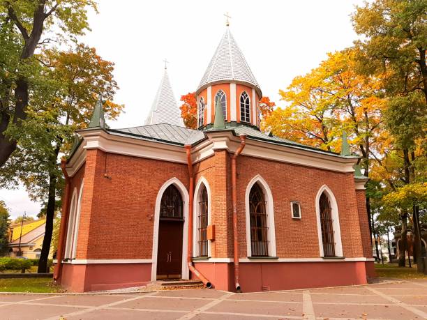 istock The red brick church is surrounded by bright autumn trees. 1341326758