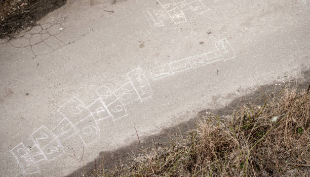 istock Playing with chalk on the asphalt 1341330153