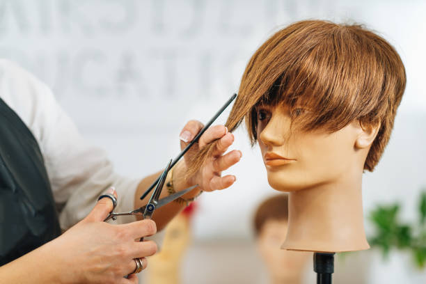 istock Haircutting Education - Hairstylist Explaining Haircutting Techniques 1341332352