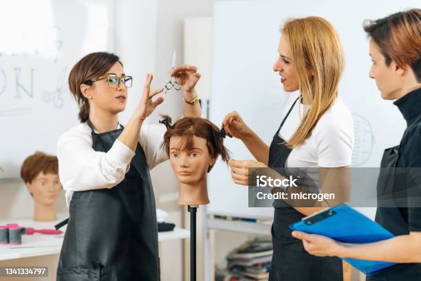 Hairdressers Training With Mannequin Head In Education Center Stock Photo - Download Image Now