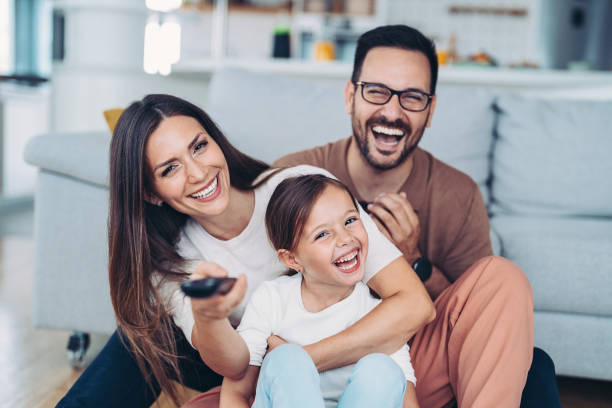 istock Cheerful family with TV remote control 1341334837