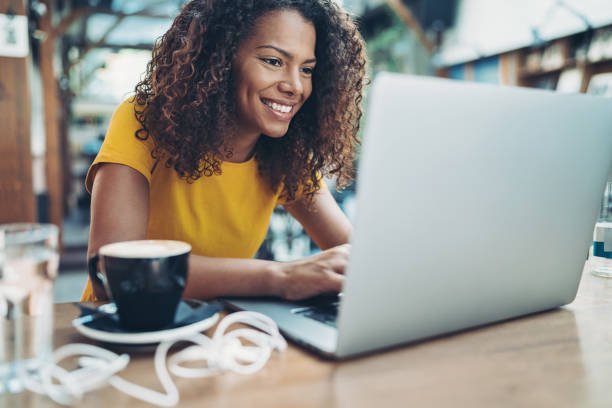 istock Smiling young woman with a laptop 1341334839