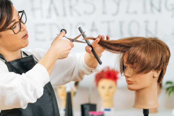 istock Haircutting Education - Hairstylist Explaining Haircutting Techniques 1341334896