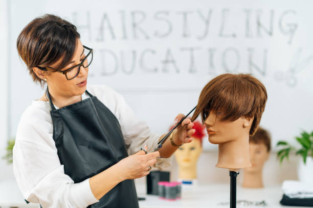 istock Haircutting Education - Hairstylist Explaining Haircutting Techniques 1341334915