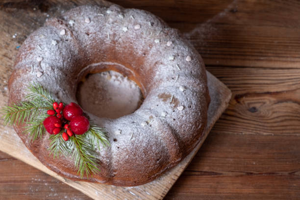 istock Christmas cake with a hole on a wooden board. Blur and selective focus 1341334945