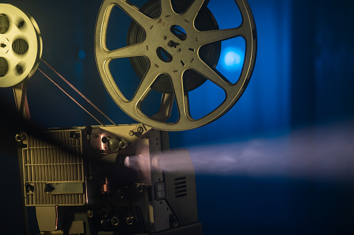 Photo of old fashioned 16mm movie projector. No people are seen in frame. Shot with a full frame mirrorless camera.