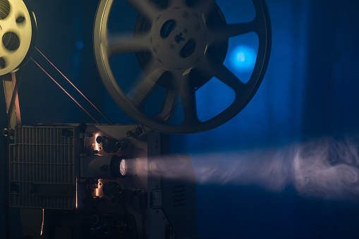 Photo of old fashioned 16mm movie projector. No people are seen in frame. Shot with a full frame mirrorless camera.